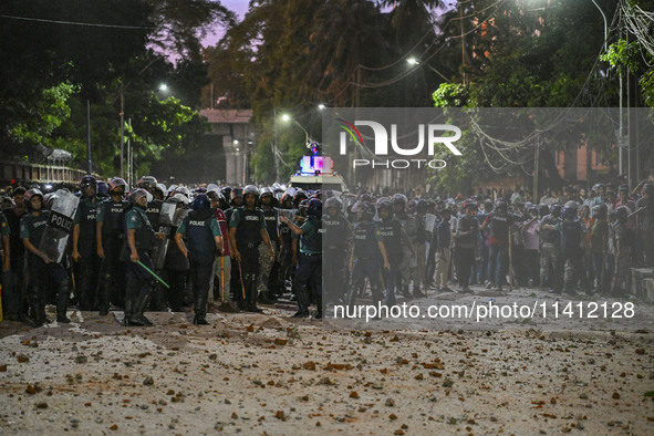 Bangladesh riot police are taking a position in front of Shahidullah Hall during clashes between anti-quota protesters and students backing...