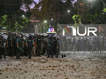 Bangladesh riot police are taking a position in front of Shahidullah Hall during clashes between anti-quota protesters and students backing...