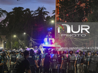 Bangladesh riot police are taking a position in front of Shahidullah Hall during clashes between anti-quota protesters and students backing...