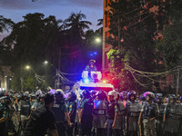 Bangladesh riot police are taking a position in front of Shahidullah Hall during clashes between anti-quota protesters and students backing...