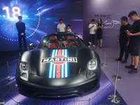 People are looking at Porsche's hybrid supercar ''918 Spyder'' at the West Lake in Hangzhou, China, on July 16, 2024. (