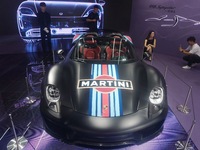 People are looking at Porsche's hybrid supercar ''918 Spyder'' at the West Lake in Hangzhou, China, on July 16, 2024. (