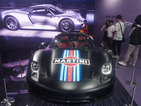 People are looking at Porsche's hybrid supercar ''918 Spyder'' at the West Lake in Hangzhou, China, on July 16, 2024. (