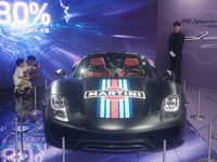 People are looking at Porsche's hybrid supercar ''918 Spyder'' at the West Lake in Hangzhou, China, on July 16, 2024. (