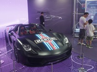 People are looking at Porsche's hybrid supercar ''918 Spyder'' at the West Lake in Hangzhou, China, on July 16, 2024. (