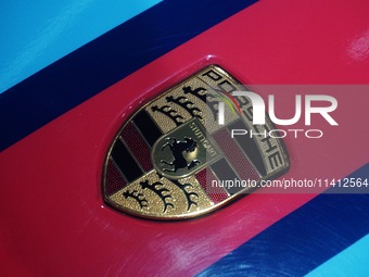 A Porsche logo is being pictured on the body of a supercar ''918 Spyder'' at the West Lake in Hangzhou, China, on July 16, 2024. (