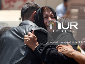 Relatives of the Palestinians, who are dying in Israeli attacks, are mourning at Al-Aqsa Martyr's Hospital in Deir al-Balah, Gaza, on July 1...