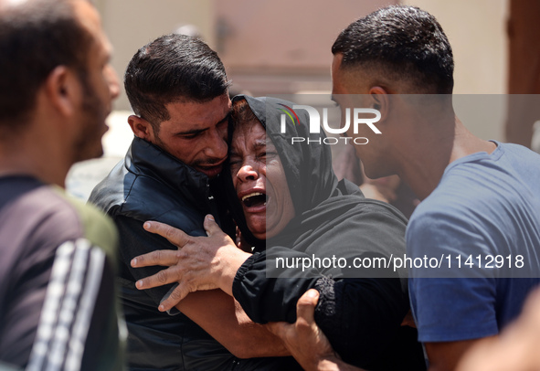 Relatives of the Palestinians, who are dying in Israeli attacks, are mourning at Al-Aqsa Martyr's Hospital in Deir al-Balah, Gaza, on July 1...