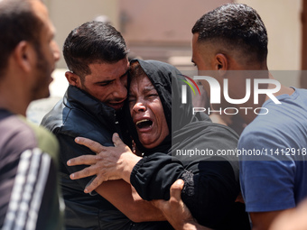 Relatives of the Palestinians, who are dying in Israeli attacks, are mourning at Al-Aqsa Martyr's Hospital in Deir al-Balah, Gaza, on July 1...