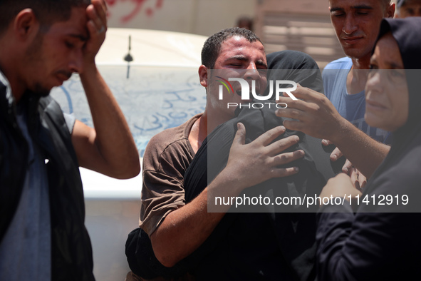 Relatives of the Palestinians, who are dying in Israeli attacks, are mourning at Al-Aqsa Martyr's Hospital in Deir al-Balah, Gaza, on July 1...