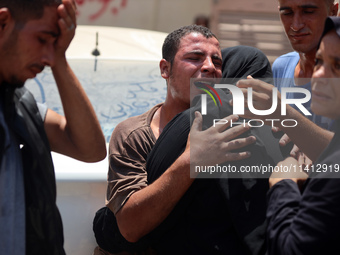 Relatives of the Palestinians, who are dying in Israeli attacks, are mourning at Al-Aqsa Martyr's Hospital in Deir al-Balah, Gaza, on July 1...