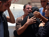 Relatives of the Palestinians, who are dying in Israeli attacks, are mourning at Al-Aqsa Martyr's Hospital in Deir al-Balah, Gaza, on July 1...