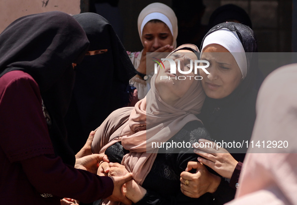 Relatives of the Palestinians, who are dying in Israeli attacks, are mourning at Al-Aqsa Martyr's Hospital in Deir al-Balah, Gaza, on July 1...