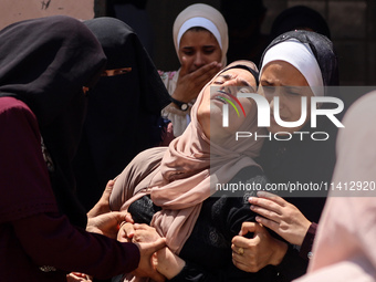 Relatives of the Palestinians, who are dying in Israeli attacks, are mourning at Al-Aqsa Martyr's Hospital in Deir al-Balah, Gaza, on July 1...