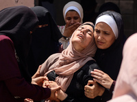 Relatives of the Palestinians, who are dying in Israeli attacks, are mourning at Al-Aqsa Martyr's Hospital in Deir al-Balah, Gaza, on July 1...