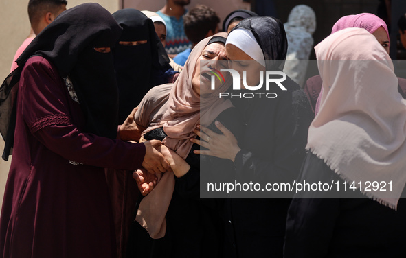 Relatives of the Palestinians, who are dying in Israeli attacks, are mourning at Al-Aqsa Martyr's Hospital in Deir al-Balah, Gaza, on July 1...