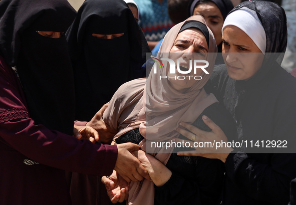 Relatives of the Palestinians, who are dying in Israeli attacks, are mourning at Al-Aqsa Martyr's Hospital in Deir al-Balah, Gaza, on July 1...