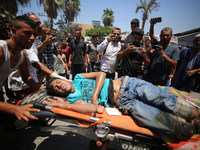 Injured Palestinians are being brought to Al-Aqsa Martyrs Hospital for medical treatment after the Israeli attacks in Deir al-Balah, Gaza, o...