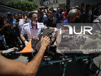 Injured Palestinians are being brought to Al-Aqsa Martyrs Hospital for medical treatment after the Israeli attacks in Deir al-Balah, Gaza, o...