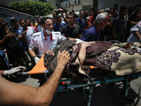 Injured Palestinians are being brought to Al-Aqsa Martyrs Hospital for medical treatment after the Israeli attacks in Deir al-Balah, Gaza, o...