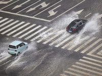 Vehicles are driving through heavy rain in the West Coast New Area of Qingdao, Shandong province, China, on July 16, 2024. (