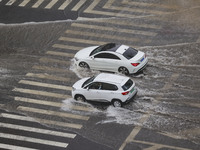 Vehicles are driving through heavy rain in the West Coast New Area of Qingdao, Shandong province, China, on July 16, 2024. (