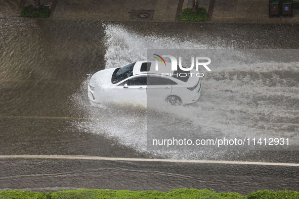 Vehicles are driving through heavy rain in the West Coast New Area of Qingdao, Shandong province, China, on July 16, 2024. 