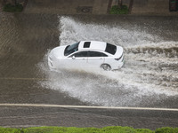 Vehicles are driving through heavy rain in the West Coast New Area of Qingdao, Shandong province, China, on July 16, 2024. (