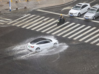 Vehicles are driving through heavy rain in the West Coast New Area of Qingdao, Shandong province, China, on July 16, 2024. (