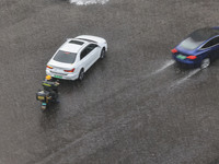 Vehicles are driving through heavy rain in the West Coast New Area of Qingdao, Shandong province, China, on July 16, 2024. (