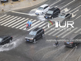 Vehicles are driving through heavy rain in the West Coast New Area of Qingdao, Shandong province, China, on July 16, 2024. (