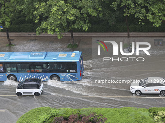 Vehicles are driving through heavy rain in the West Coast New Area of Qingdao, Shandong province, China, on July 16, 2024. (