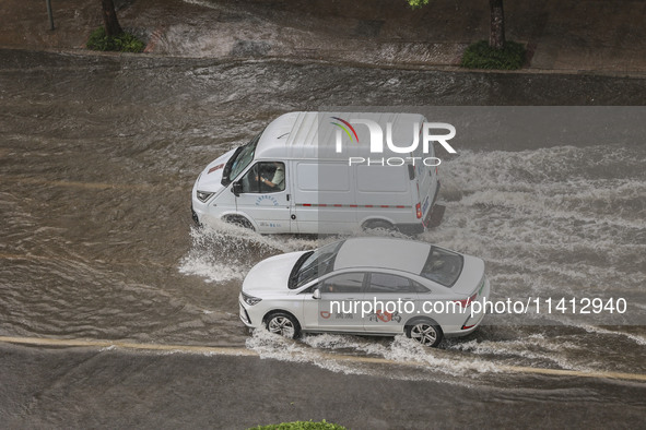 Vehicles are driving through heavy rain in the West Coast New Area of Qingdao, Shandong province, China, on July 16, 2024. 