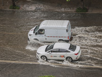 Vehicles are driving through heavy rain in the West Coast New Area of Qingdao, Shandong province, China, on July 16, 2024. (