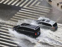 Vehicles are driving through heavy rain in the West Coast New Area of Qingdao, Shandong province, China, on July 16, 2024. (