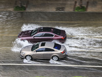 Vehicles are driving through heavy rain in the West Coast New Area of Qingdao, Shandong province, China, on July 16, 2024. (