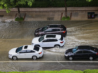 Vehicles are driving through heavy rain in the West Coast New Area of Qingdao, Shandong province, China, on July 16, 2024. (