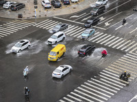 Vehicles are driving through heavy rain in the West Coast New Area of Qingdao, Shandong province, China, on July 16, 2024. (