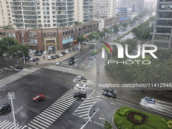 Vehicles are driving through heavy rain in the West Coast New Area of Qingdao, Shandong province, China, on July 16, 2024. (