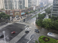 Vehicles are driving through heavy rain in the West Coast New Area of Qingdao, Shandong province, China, on July 16, 2024. (