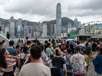 People are at Tsim Sha Tsui Promenade in Hong Kong, on July 16, 2024. (