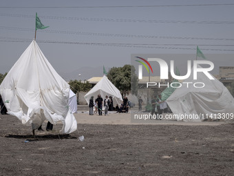 Tents that are being set up in an area, serving as symbols of the tents of Imam Hussein and his family, are being pictured during a religiou...