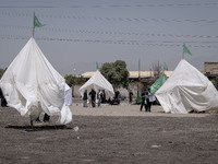 Tents that are being set up in an area, serving as symbols of the tents of Imam Hussein and his family, are being pictured during a religiou...