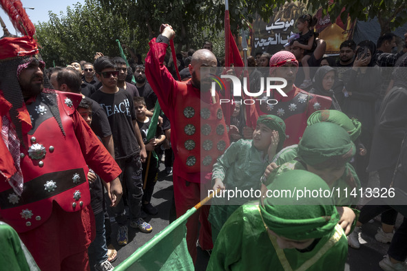 Iraqi men and children living in Iran are performing in a religious festival to commemorate Ashura in the Dolatabad neighborhood in southern...