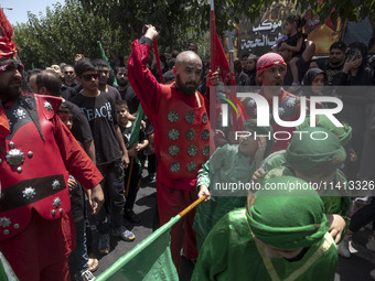 Iraqi men and children living in Iran are performing in a religious festival to commemorate Ashura in the Dolatabad neighborhood in southern...