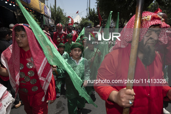 Iraqi men and children living in Iran are performing in a religious festival to commemorate Ashura in the Dolatabad neighborhood in southern...