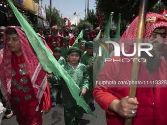 Iraqi men and children living in Iran are performing in a religious festival to commemorate Ashura in the Dolatabad neighborhood in southern...