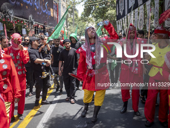 Iraqi men living in Iran are performing in a religious festival to commemorate Ashura in the Dolatabad neighborhood in southern Tehran, Iran...