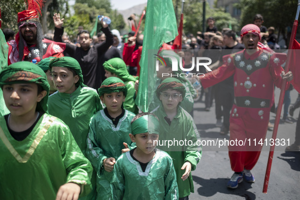 Iraqi men and children living in Iran are performing in a religious festival to commemorate Ashura in the Dolatabad neighborhood in southern...