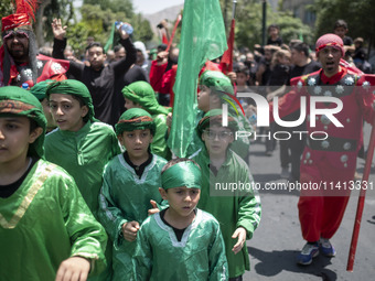 Iraqi men and children living in Iran are performing in a religious festival to commemorate Ashura in the Dolatabad neighborhood in southern...